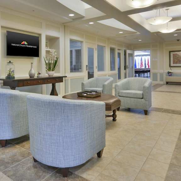 a spacious living room with a television and comfortable seating.