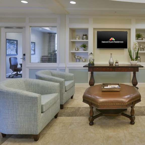 a conference room with a table in the middle and four chairs around it.