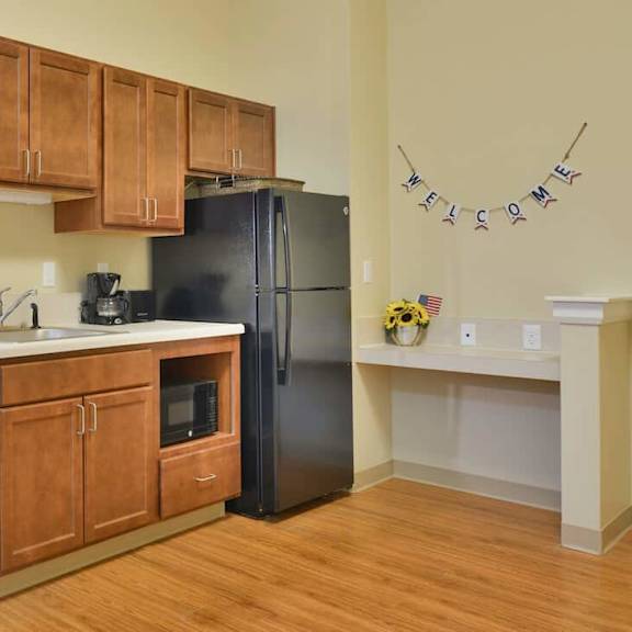a kitchen with wooden cabinets and black appliances.