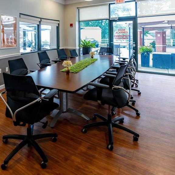 a conference room with a long table and chairs.