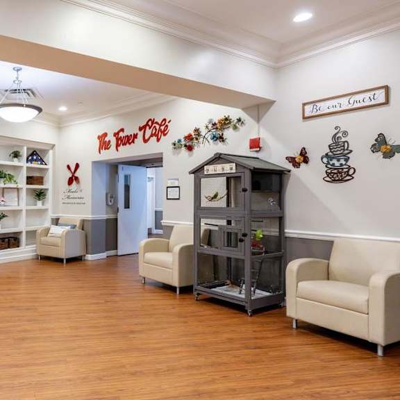 a waiting area with a coffee machine and a sign that says "breakfast".