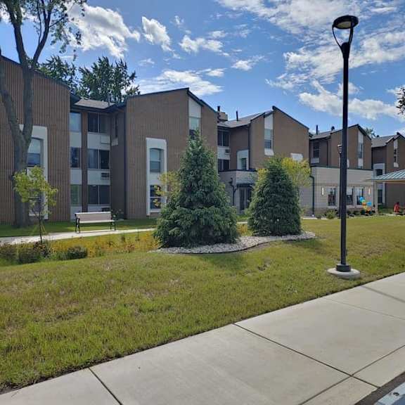 a street view of a residential area with apartment buildings.