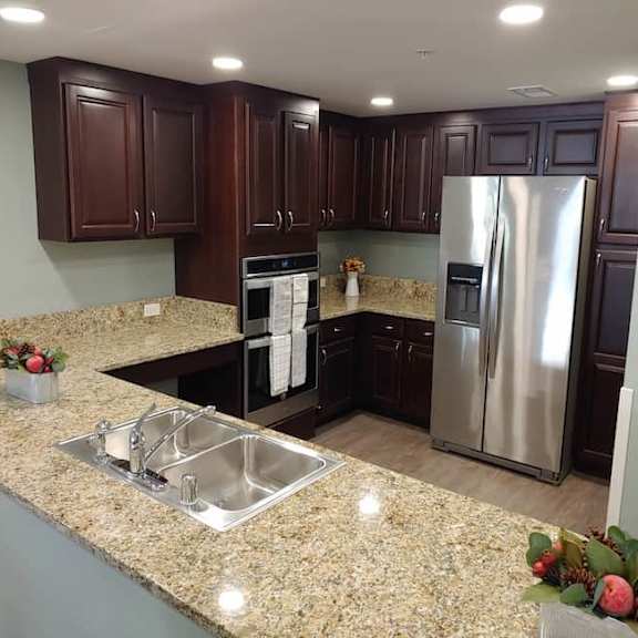 a kitchen with granite countertops and stainless steel appliances.