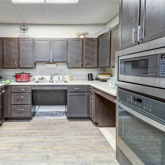 a kitchen with a refrigerator, oven, and microwave.