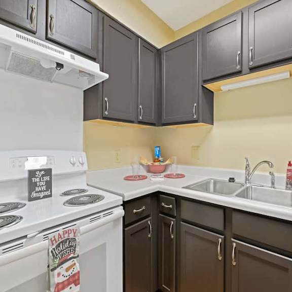 a kitchen with white appliances and brown cabinets.