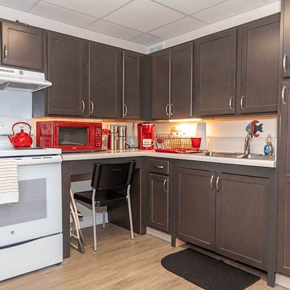 a kitchen with brown cabinets and a white oven.