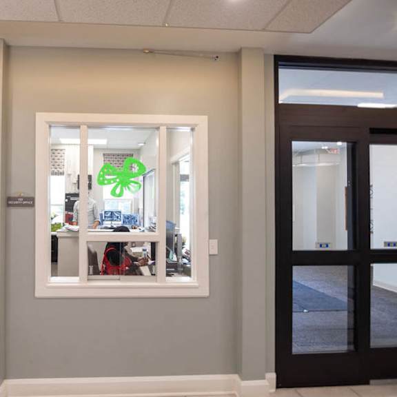 a white door is open to a room with a window.