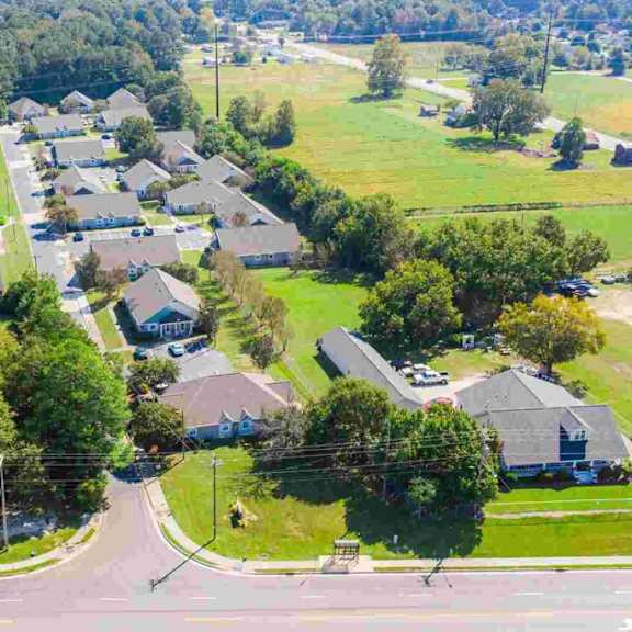 a suburban neighborhood with houses and a road.