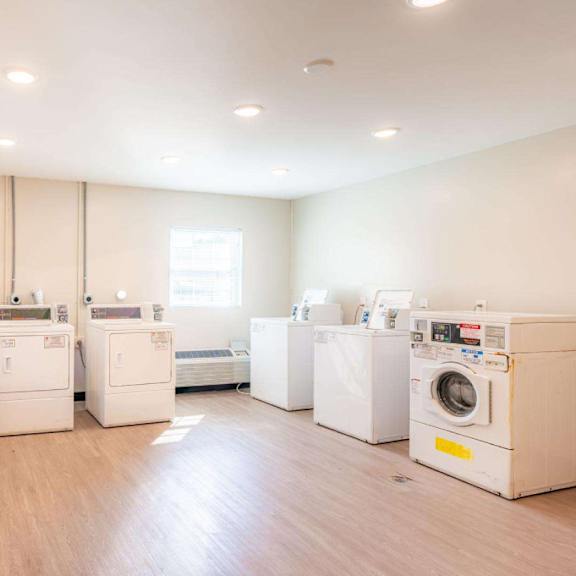 a laundry room with washers and dryers.