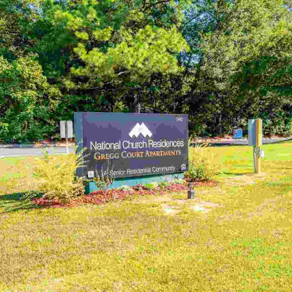 a sign for national church properties sits in front of a building.
