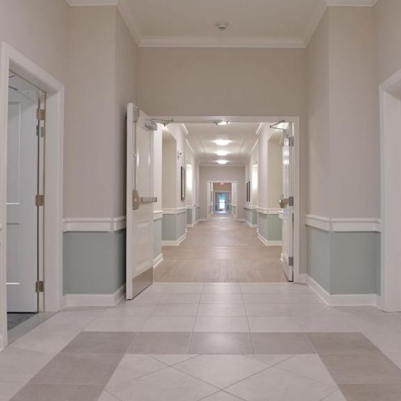 a long hallway with doors on both sides.