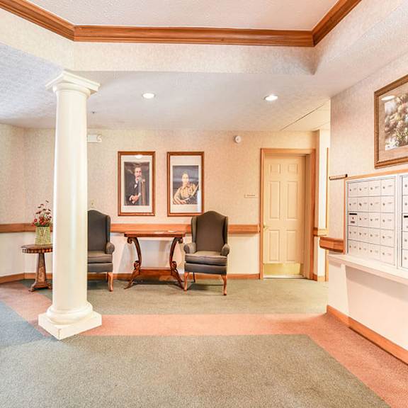 a room with a table and chairs in the middle.