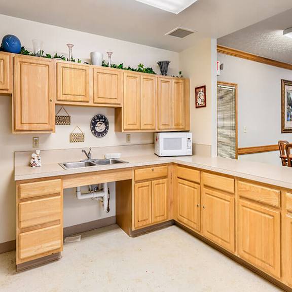 a kitchen with wooden cabinets and a white microwave.