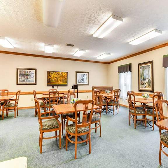 a room with wooden furniture and pictures on the wall.