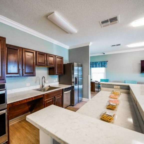 a kitchen with wooden cabinets and stainless steel appliances.
