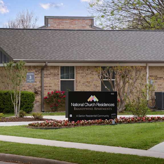 the front of a building with a sign that says national church residences.