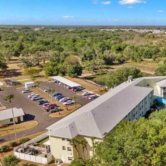 a large building with a parking lot in front of it.