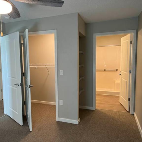 a room with a carpeted floor and a ceiling fan.