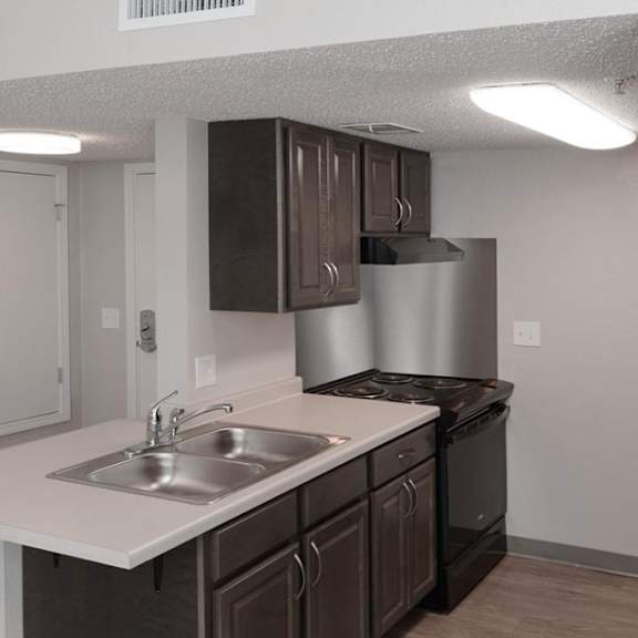 a kitchen with brown cabinets and a white countertop.