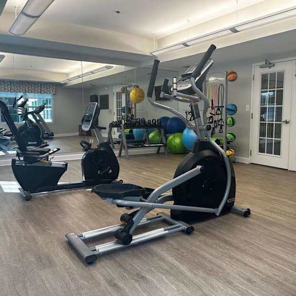 a home gym with a variety of exercise equipment.