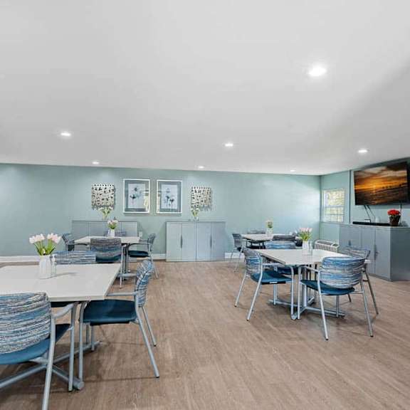 a modern kitchen with a dining table and chairs.