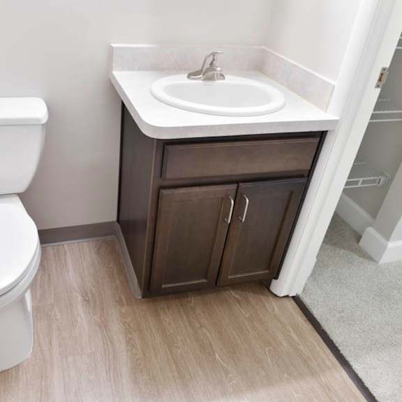 a white toilet sits next to a sink in a small bathroom.