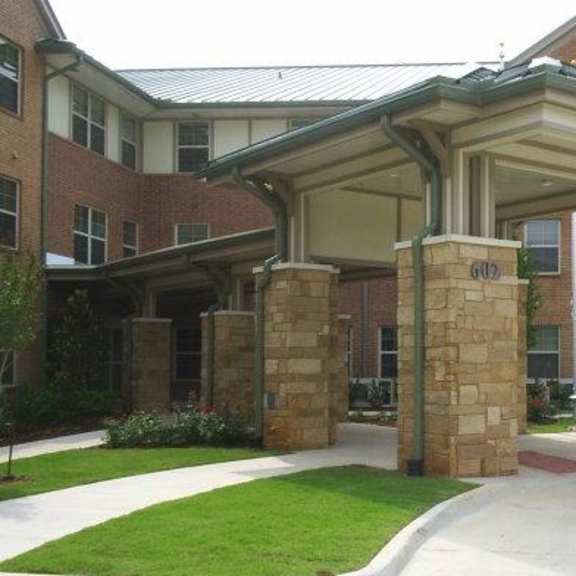 a building with a covered walkway in front.