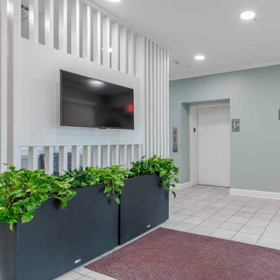 a reception area with a flat screen tv mounted on the wall.
