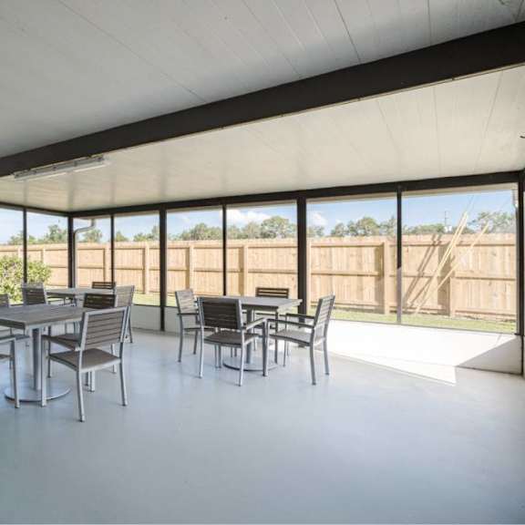 a white room with a table and chairs.