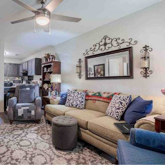 a living room with a couch, a chair, and a rug.