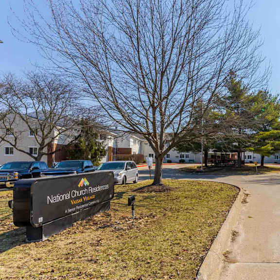 the image shows a sign for national church resorts in front of a parking lot.