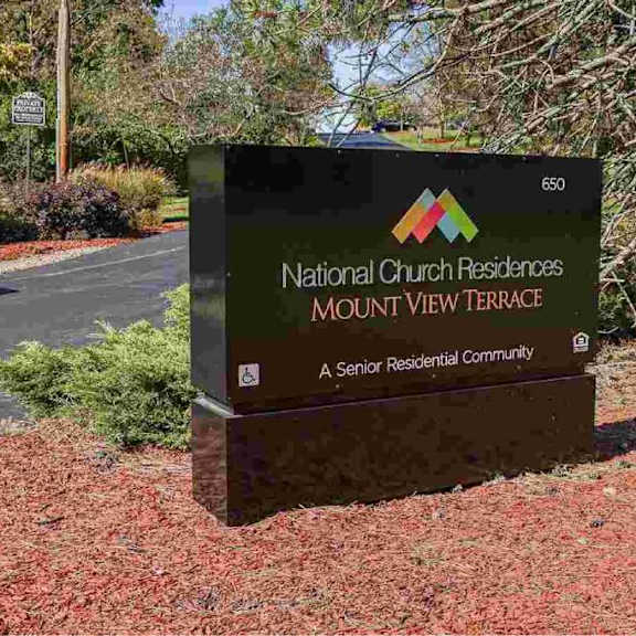 a sign for national church residences mount view terrace, a senior residential community.
