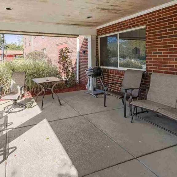 a patio with a table and chairs is shown.