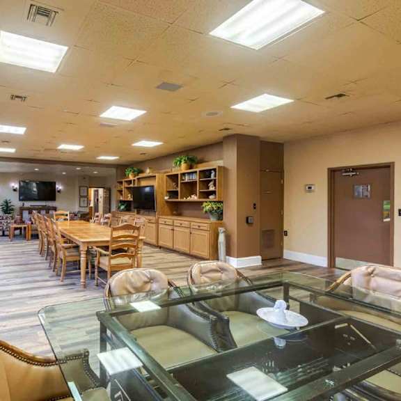 a spacious room with a glass table and chairs.