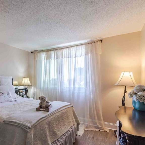 a bedroom with a large bed, two lamps, and a nightstand.