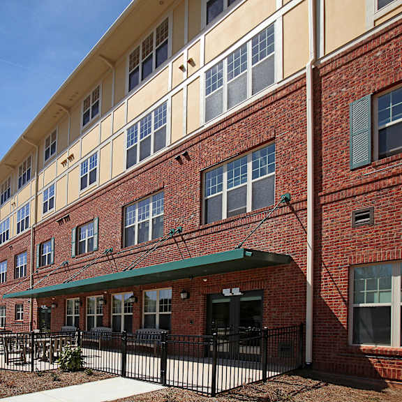 a red brick building with a green awning.