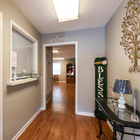 a hallway with a sign that says "rent drop" on the door.