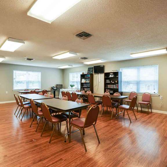 a room with a long table and chairs.