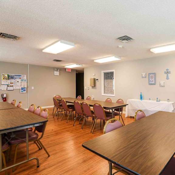 a room with a long table and chairs.