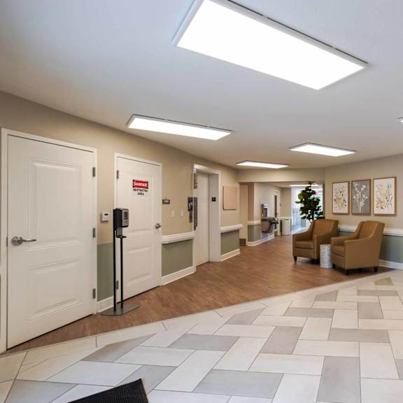 a hallway with a tiled floor and a few doors.