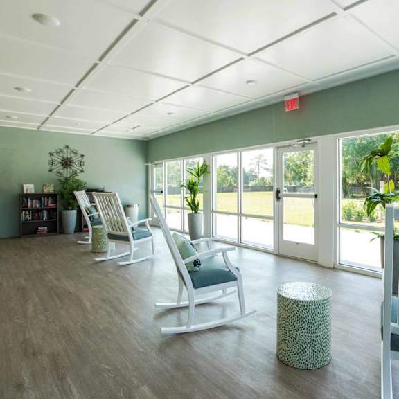 a room with a green wall and a white chair.