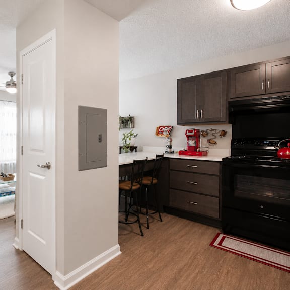 a kitchen with a black stove top oven and a white door.