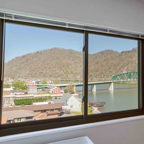 a window with a view of a bridge and a town.