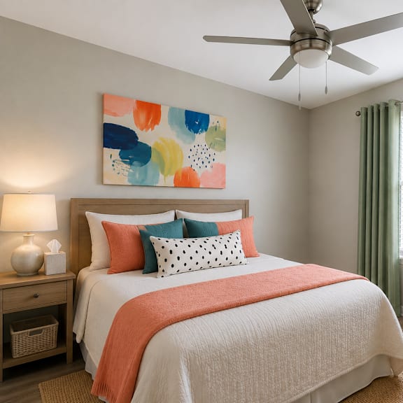a bedroom with a bed, nightstand, and a painting on the wall.