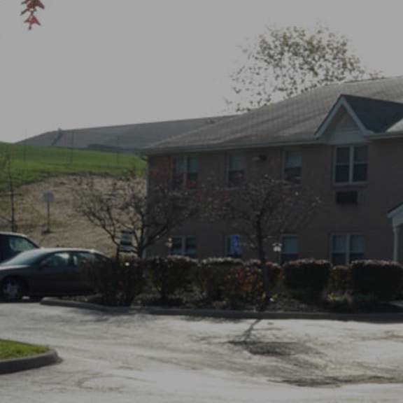 a red car is parked in front of a building.