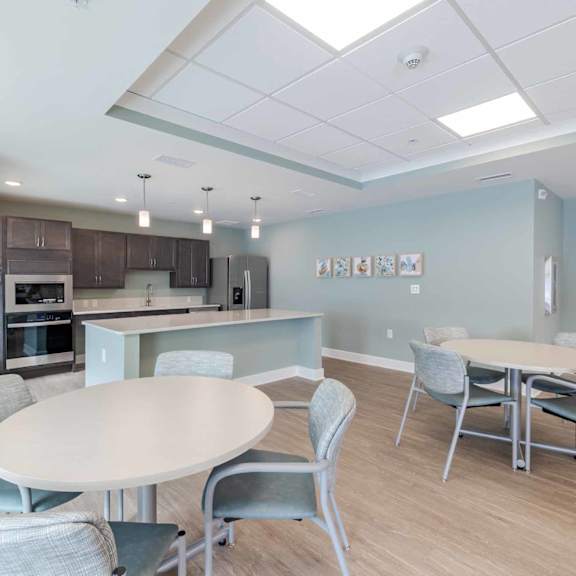 a modern kitchen with a dining table and chairs.