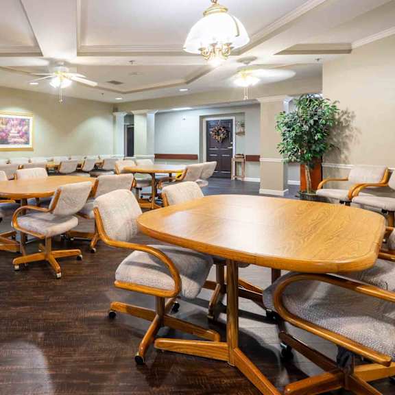 a conference room with wooden tables and chairs.