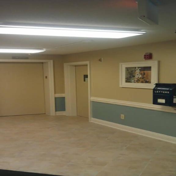 a room with two doors and a painting on the wall.
