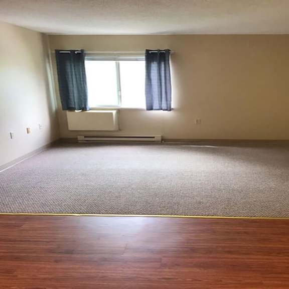 a room with a window and a white couch.