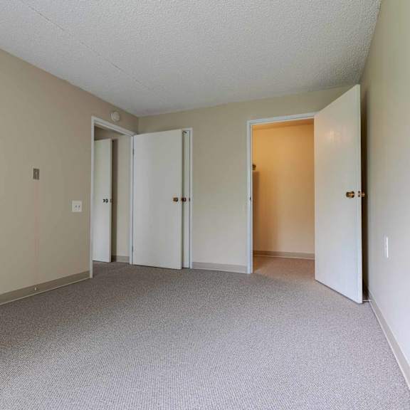a room with carpeted floor and white walls.